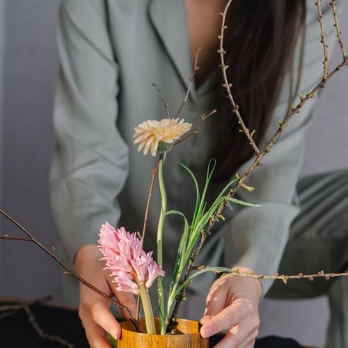 Woman meditating peacefully in a room with natural light.